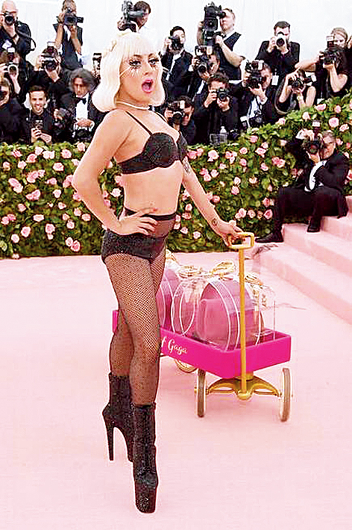 Last year at the Met Gala, Lady Gaga did four changes in different custom Brandon Maxwell creations. She entered wearing a billowy fuchsia pink gown with a massive trail, with a matching bow on her head and falsies that were almost two inches long. She later ripped one outfit after the other and stood confident in a pair of fishnet stockings, lingerie and calf-length boots.