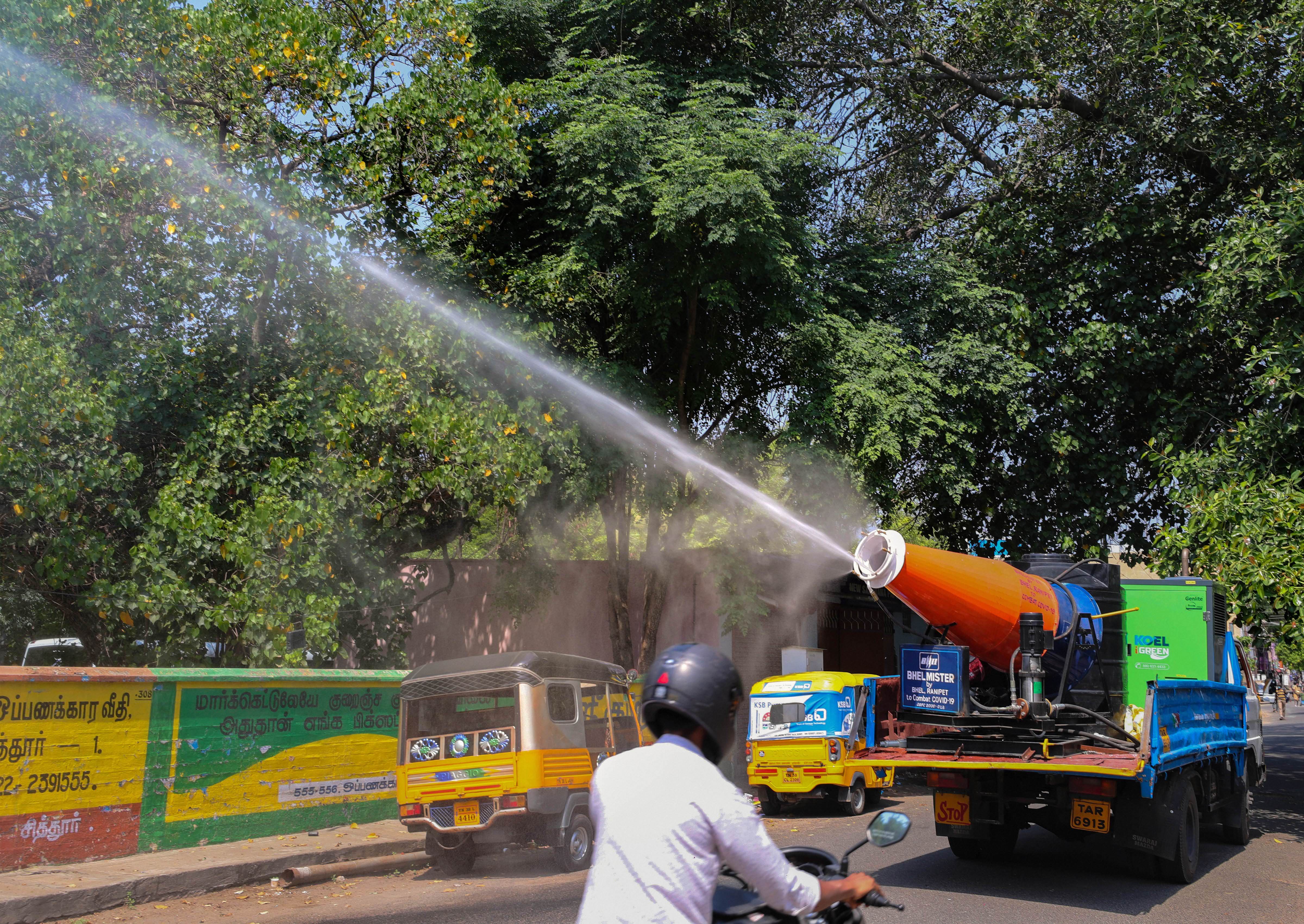 Corporation workers sanitise a street in the Townhall Market amid concerns over Covid-19 outbreak, in Coimbatore, Sunday, May 24, 2020