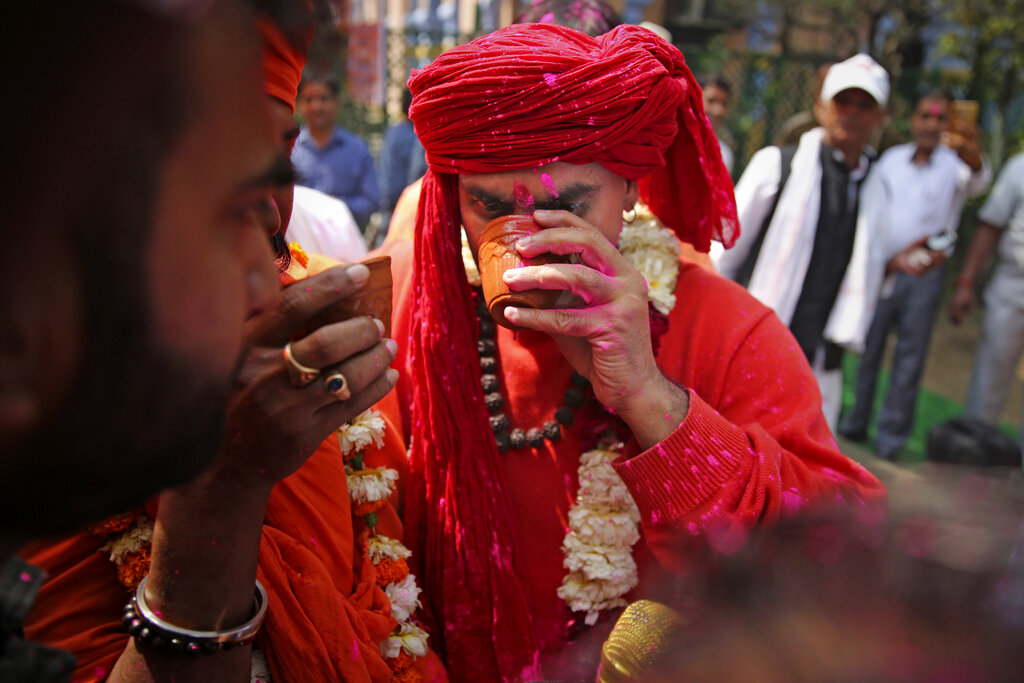 National president of Akhil Bhartiya Hindu Mahasabha Swami Chakrapani Maharaj drinks cow urine during an event organized by a Hindu religious group to promote consumption of cow urine as a cure for the new coronavirus in New Delhi, India, Saturday, March 14, 2020. The vast majority of people recover from the new coronavirus. According to the World Health Organization, people with mild illness recover in about two weeks, while those with more severe illness may take three to six weeks to recover.