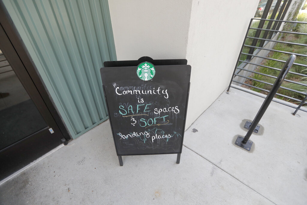 A sign at a Starbucks on South Claiborne Ave. in New Orleans reflects the community philosophy of the franchise, Thursday, Jan. 16, 2020. Starbucks, the home of the $4 latte, is expanding a program to open coffee shops in poor neighborhoods. The Seattle-based company plans to open or remodel 85 stores by 2025 in rural and urban communities across the U.S. Each store will have event space, and Starbucks will work with local United Way chapters to offer programs like youth job training.