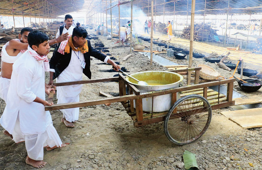Devotees prepare food at the 89th annual session of Srimanta Sankaradeva Sangha at Kamargaon in Golaghat district on Wednesday