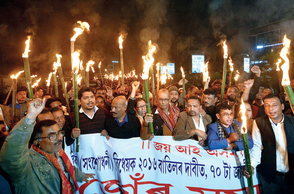 Activists of the KMSS and other organisations take out a torchlight rally in Guwahati. 