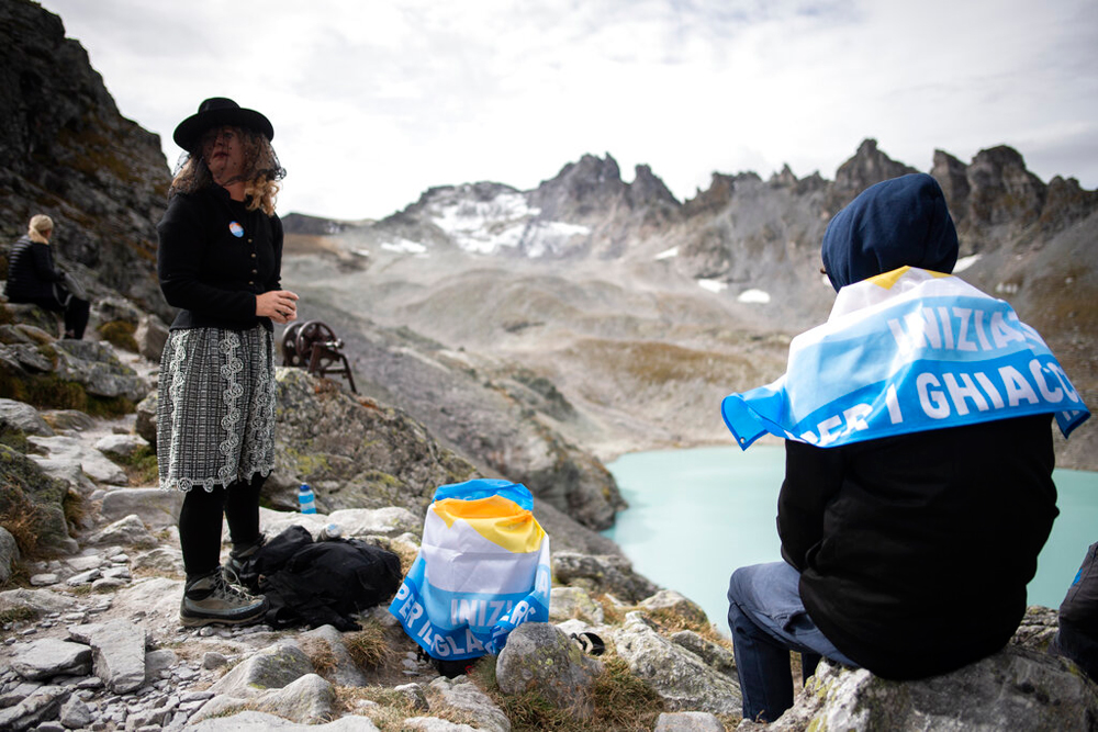 A climate change activist wears a mourning veil on her way to a ceremony to commemorate the 'dying' glacier of Pizol mountain in Wangs, Switzerland, on Sunday