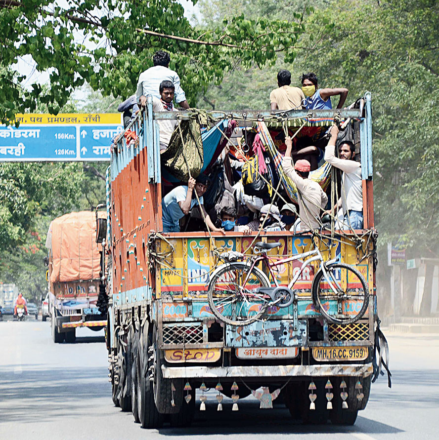 RISKY RIDE: Migrant labourers from Sahebganj, who were stranded in Odisha because of the lockdown, on their way home on a truck via HB Road in Ranchi on Monday.