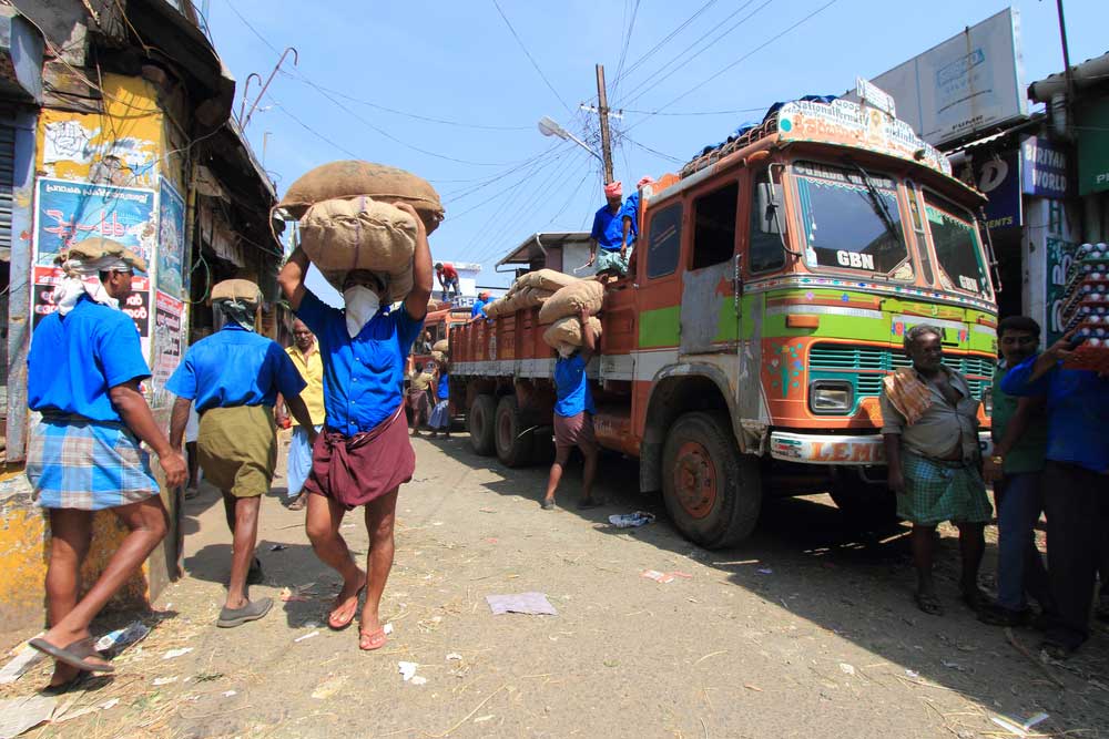 Workers unload gunny bags from a truck in Kochi. The committee has suggested that the minimum wage should not be less than Rs 375 for work done for the government, private establishments and individuals.