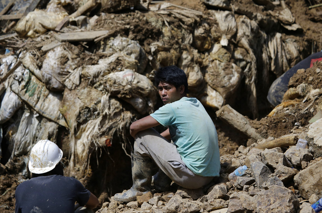 A miner waits for news as search continues for victims believed to be buried.