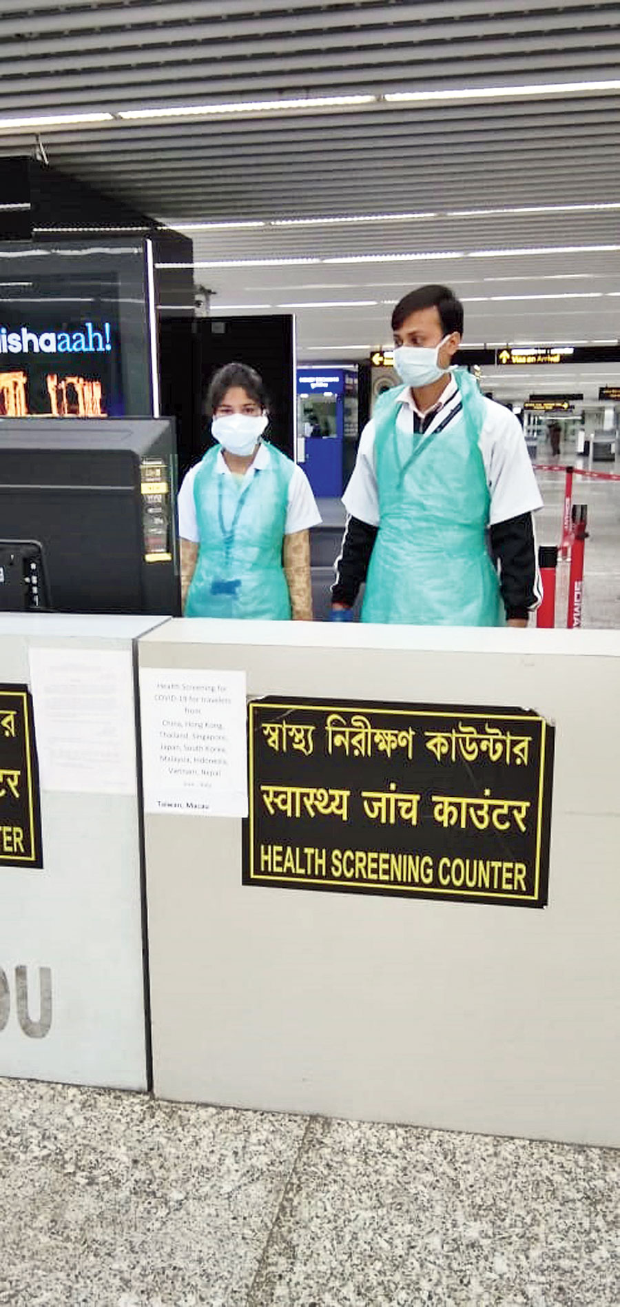 Airport health office staff at the screening counter with masks
