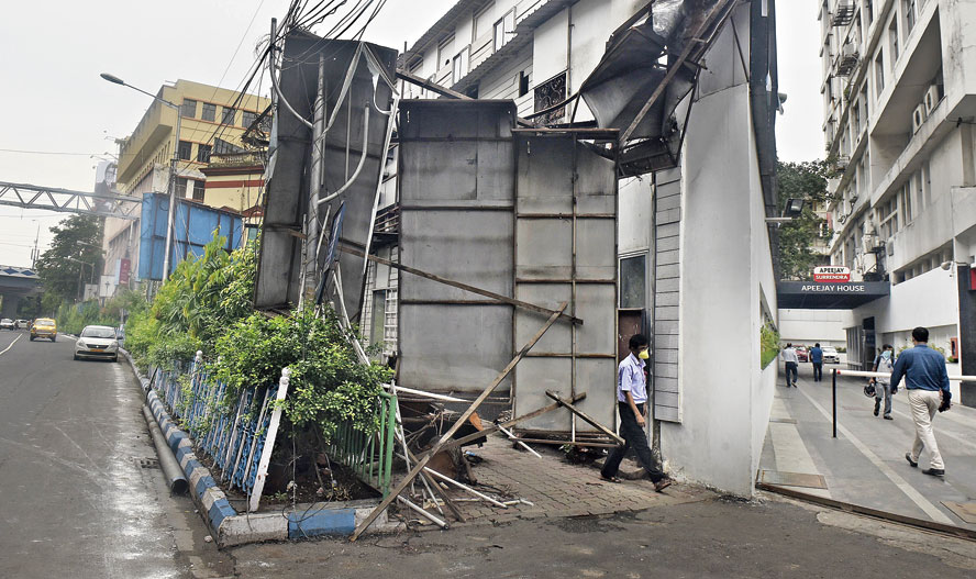 Then: An overturned billboard blocking the footpath in front of Apeejay House on Park Street on June 13.