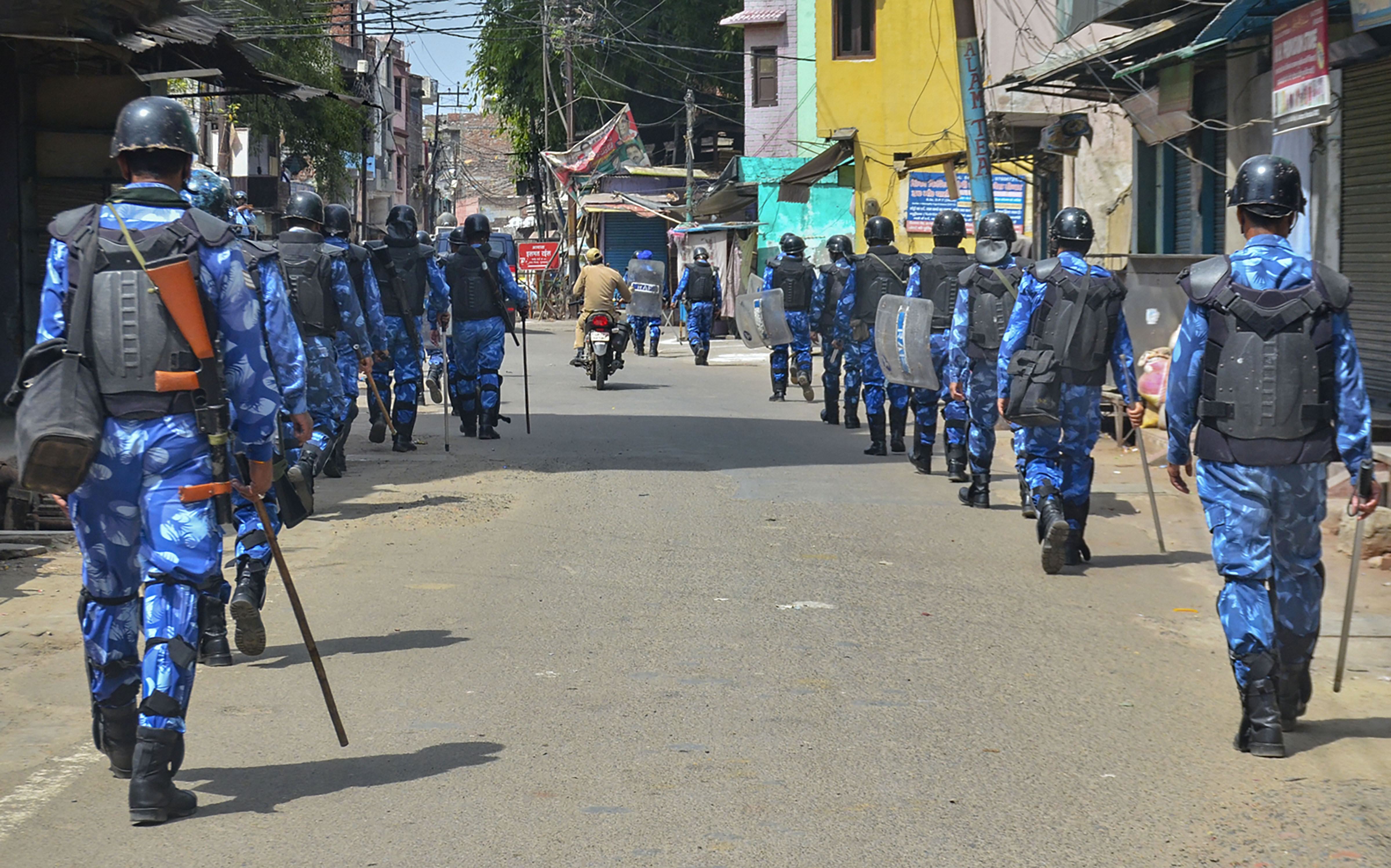 Rapid Action Force (RAF) personnel conduct a flag march during the lockdown imposed in wake of the coronavirus pandemic, in Moradabad, Thursday, April 9, 2020.