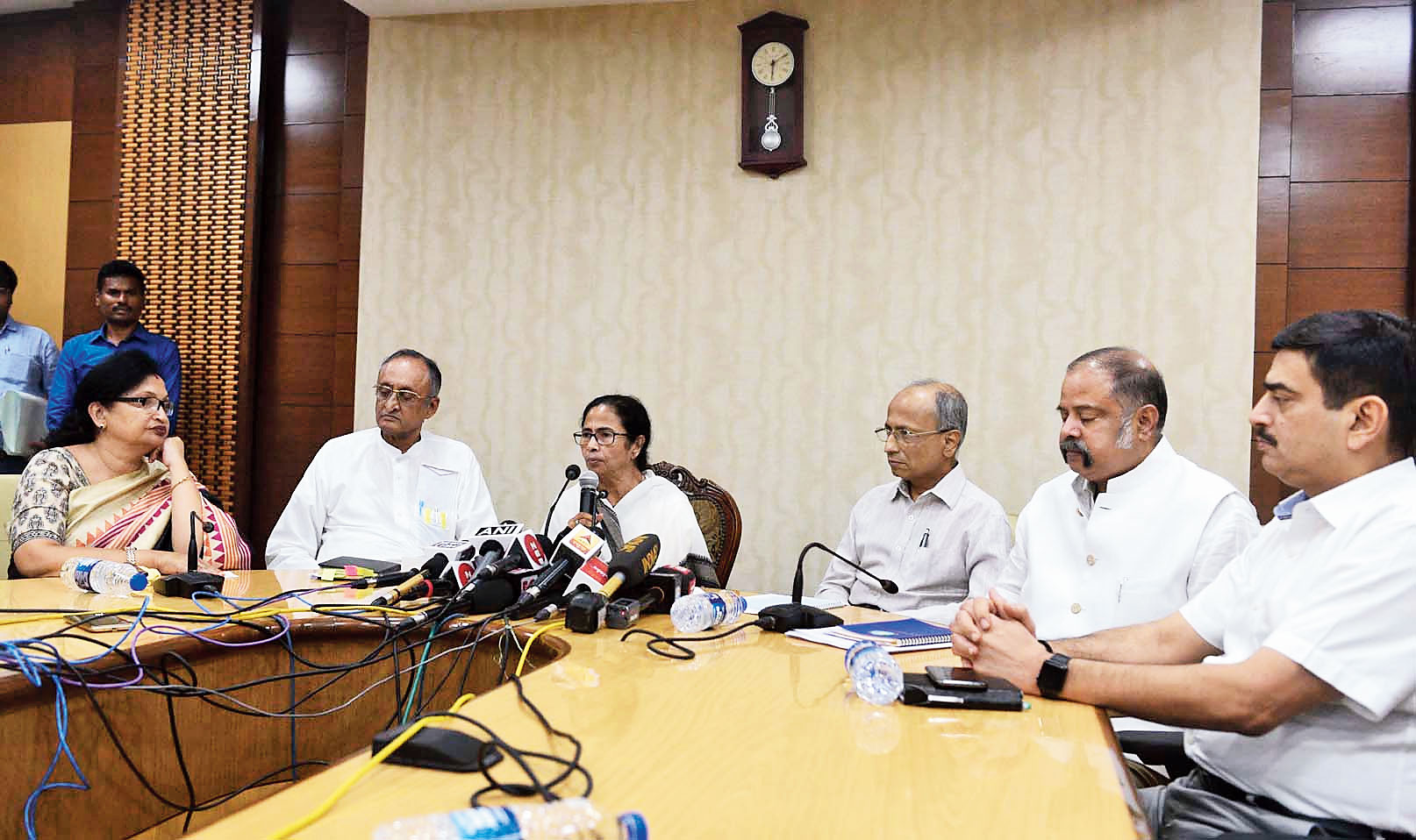 Chief minister Mamata Banerjee flanked by Chandrima Bhattacharya and Amit Mitra (on the left) and Anuj Sharma, Rajiva Sinha and Malay De (on the right) at Nabanna on Saturday. 

