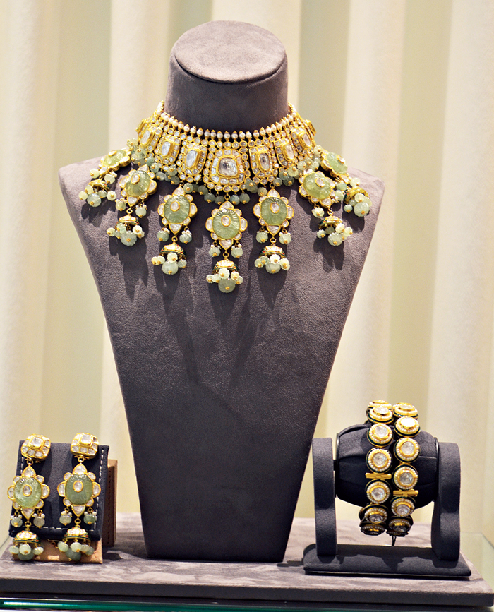 Pair this pastel-hued 18-carat gold bridal set studded with polkis, pearls and Russian emerald, with a contrast-coloured lehnga for a glam-chic look. 
Rs 25,00,000 @ Nemichand Bamalwa and Sons (J)