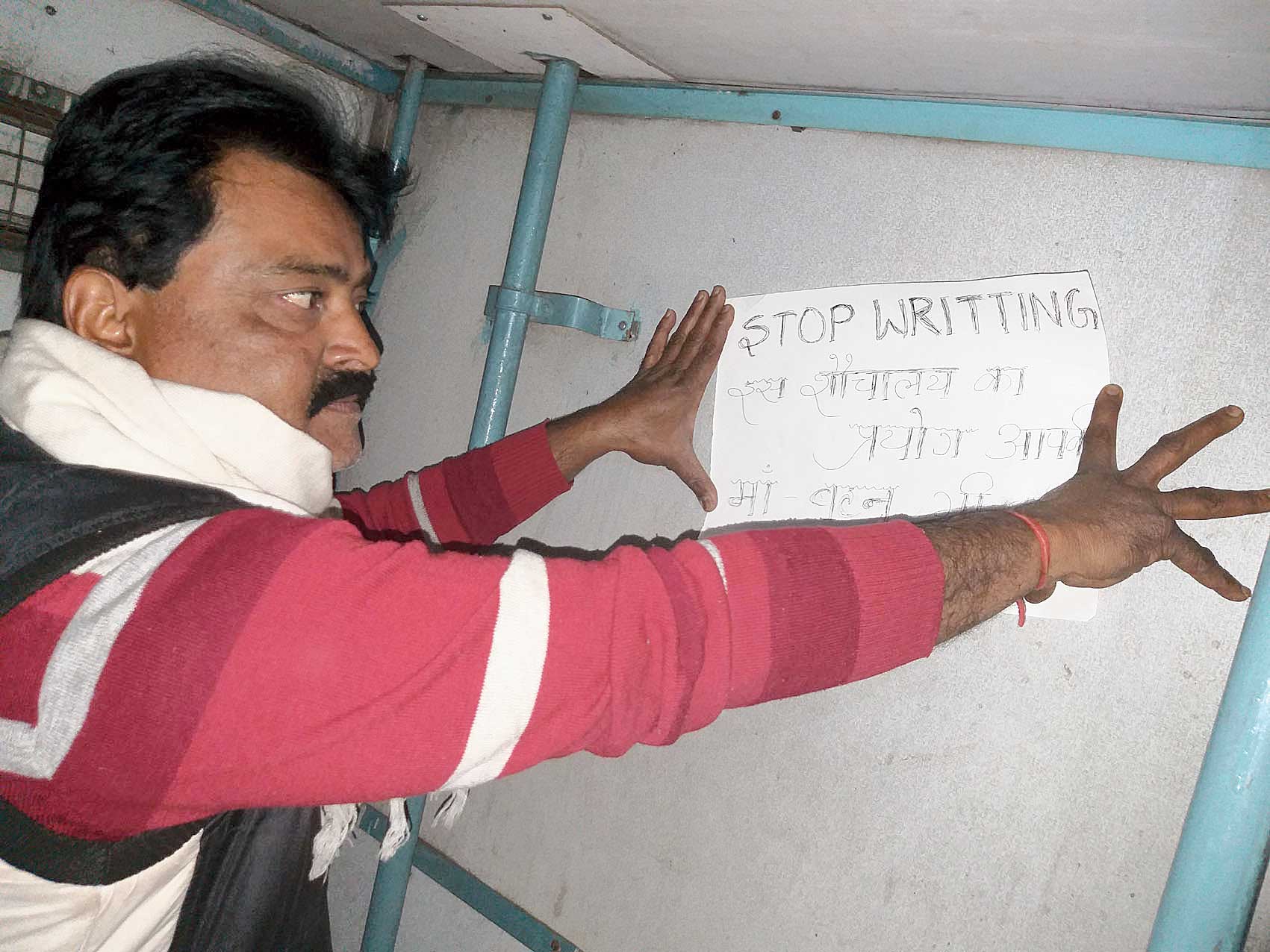 Uttam Sinha pastes a handwritten message inside the toilet of Ganga-Satlej Express in Dhanbad station earlier this week. 
