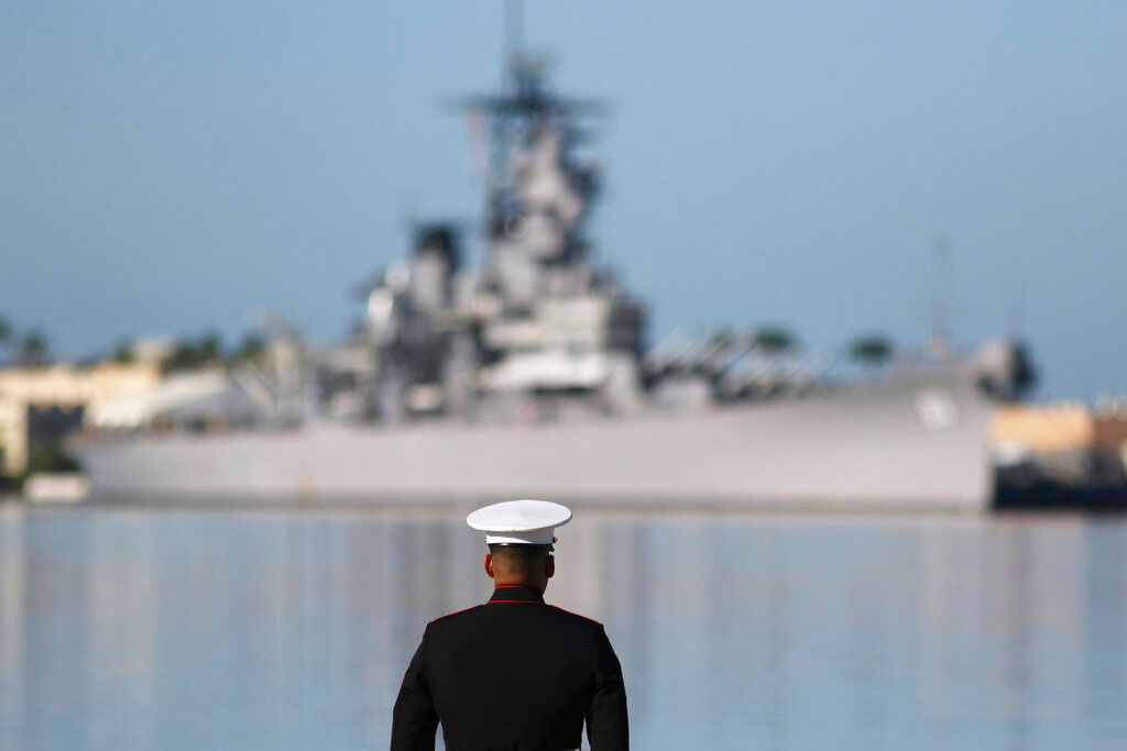 A US Marine stands in front of the USS Missouri during a ceremony to mark the 78th anniversary of the Japanese attack on Pearl Harbor, on Saturday. Survivors and members of the public gathered to remember those killed when Japanese planes bombed the naval base 78 years ago and launched the US into World War II. About a dozen survivors of the attack attended the annual ceremony, the youngest of whom are now in their late 90s.