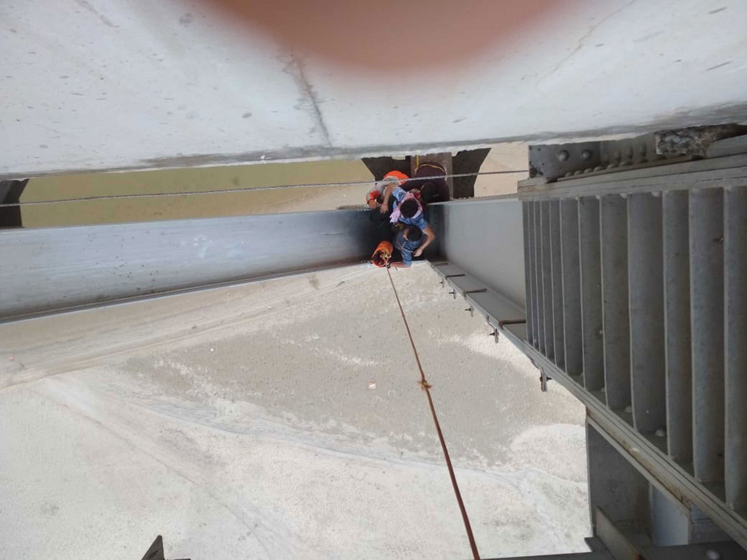 The NDRF personnel extricate the youth from among the girders