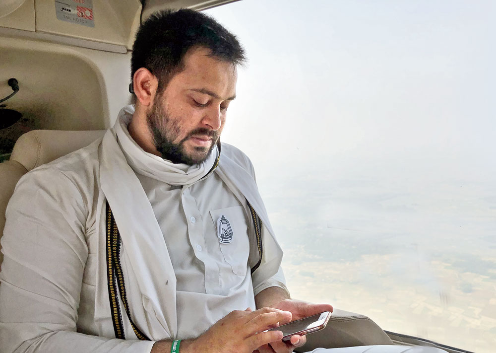 Tejashwi Prasad Yadav maps out the next stop on the campaign trail across Bihar in a chopper.