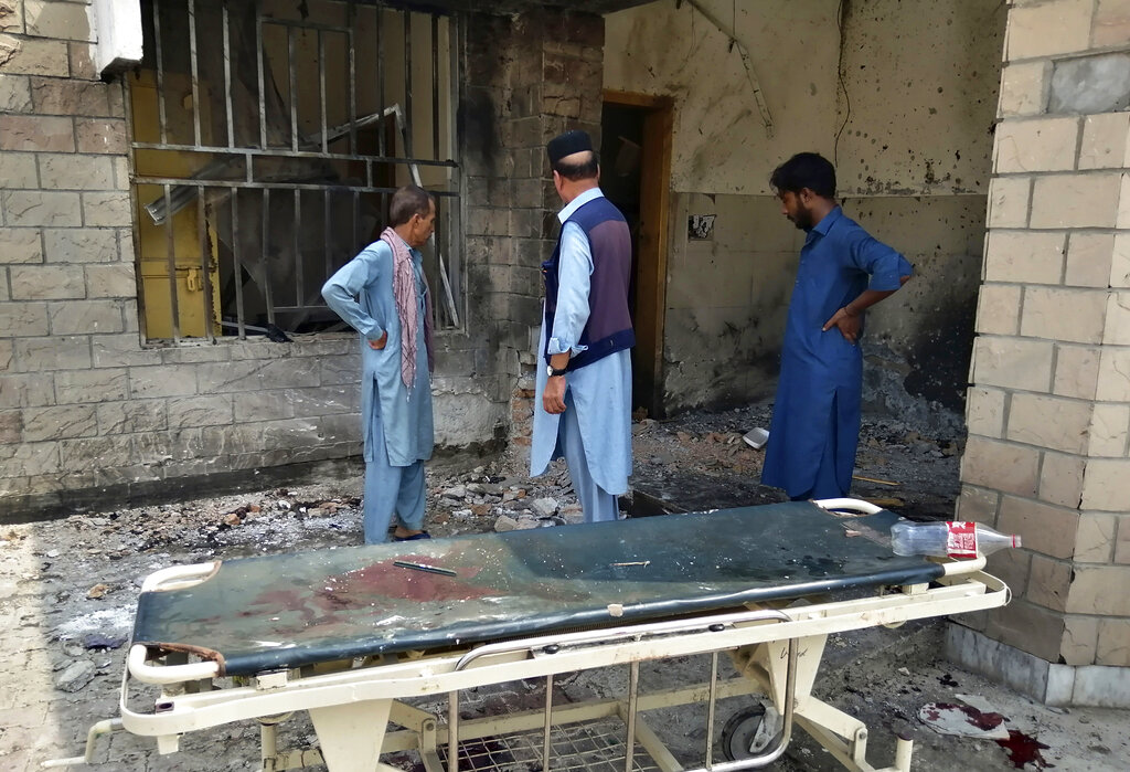 Hospital staff gather at the site of a bombing on an entrance of a hospital in Dera Ismail Khan, Pakistan, on Sunday, July 21, 2019.