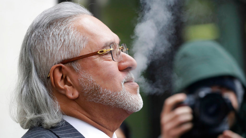 Vijay Mallya takes a break outside the Westminster Magistrates' Court in London on Monday.
