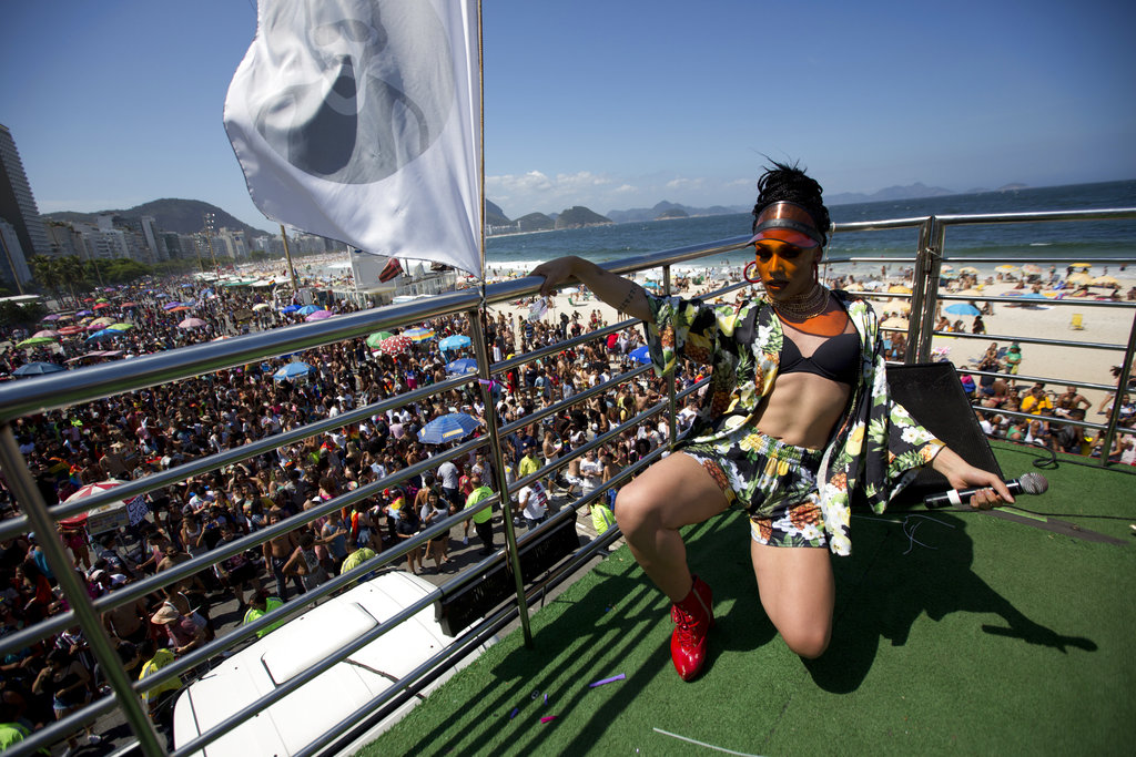 A singer performs on top of a party bus.