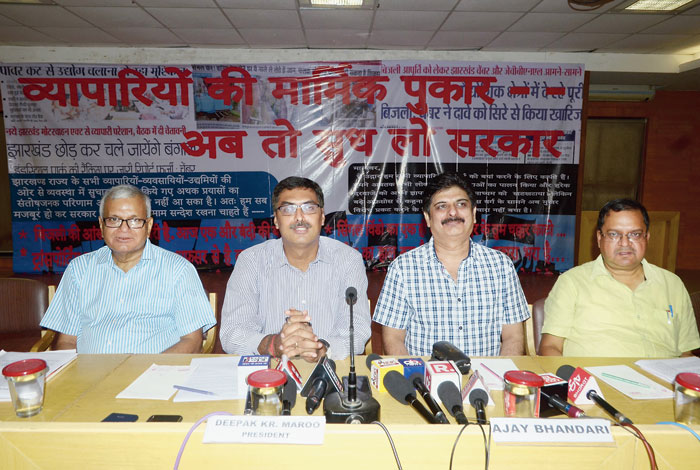 FJCCI president Deepak Kumar Maroo (second from left) addresses the media in Ranchi on Wednesday and (right) one of the  hoardings put up near the official residence of chief minister Raghubar Das on Kanke Road to remind him of  the problems faced by industrialists of the state. 