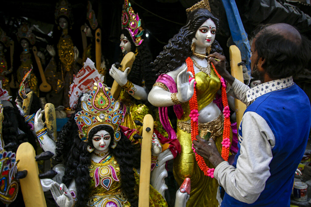 An artist gives finishing touch to a clay image of Saraswati, the Hindu goddess of wisdom, at his studio ahead of Basant Panchami in Kolkata