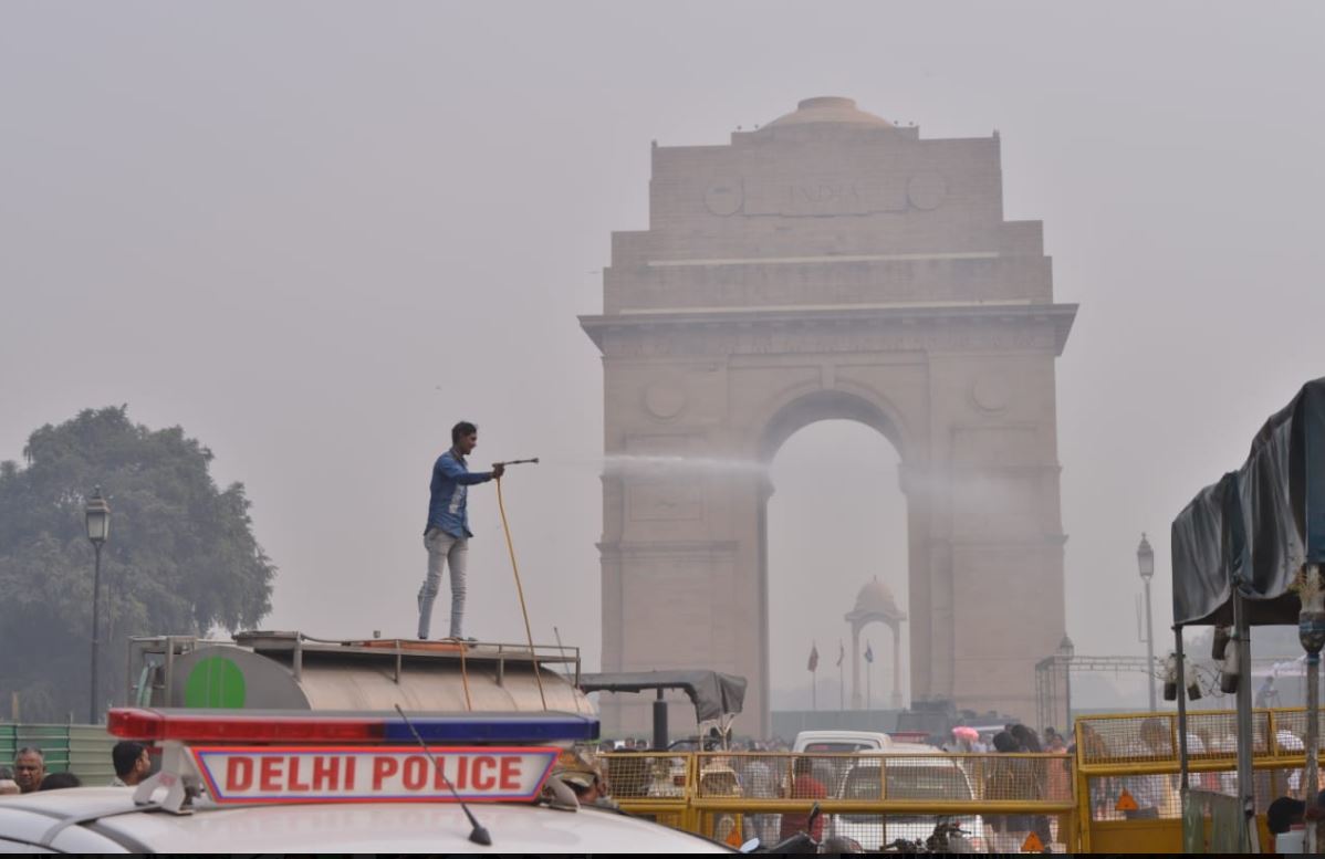 NDMC workers spraying water on trees to tackle air pollution at India Gate on Monday.