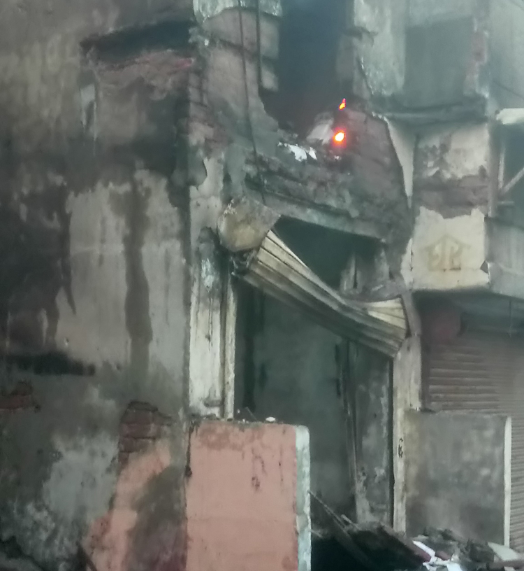 A shop in Gokulpuri in northeast Delhi burns after being set on fire by protesters on Tuesday
