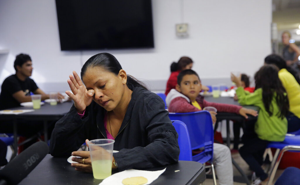Deysi Yanira Centeno wipes a tear as she describes fleeing El Salvador with three of her children, aged 7, 11, and 15, at the Catholic Charities shelter in McAllen, Texas. Centeno reached the border a month after fleeing El Salvador, where gangs threatened her 15-year-old daughter.