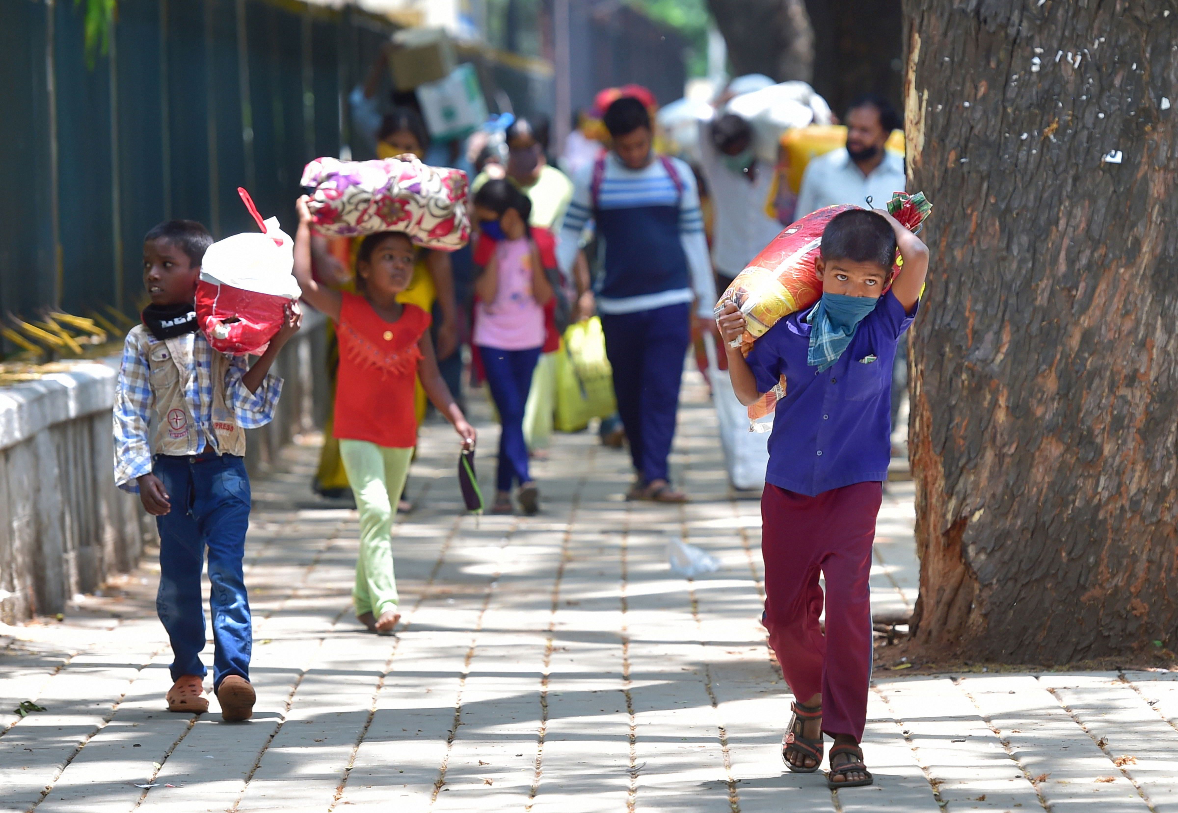 Children of migrant workers arrive at the District Collectors office, after the government allowed people to travel to their respective destinations with certain conditions amid the coronavirus pandemic, in Bengaluru, Friday, May 1, 2020.