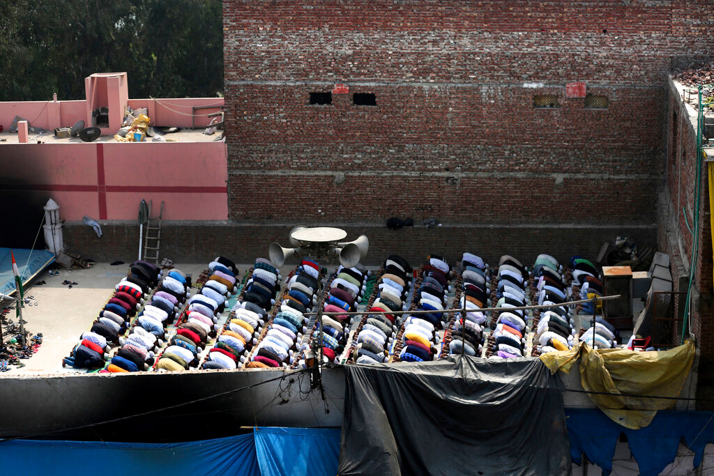 People offer prayers on the roof of a mosque in New Delhi on Friday