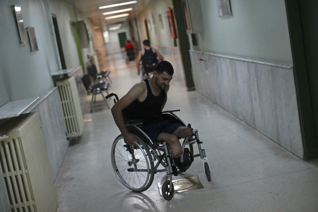 Omar Beik, a 32-year-old soldier from Aleppo, who lost his legs in April when he stepped on a land mine.