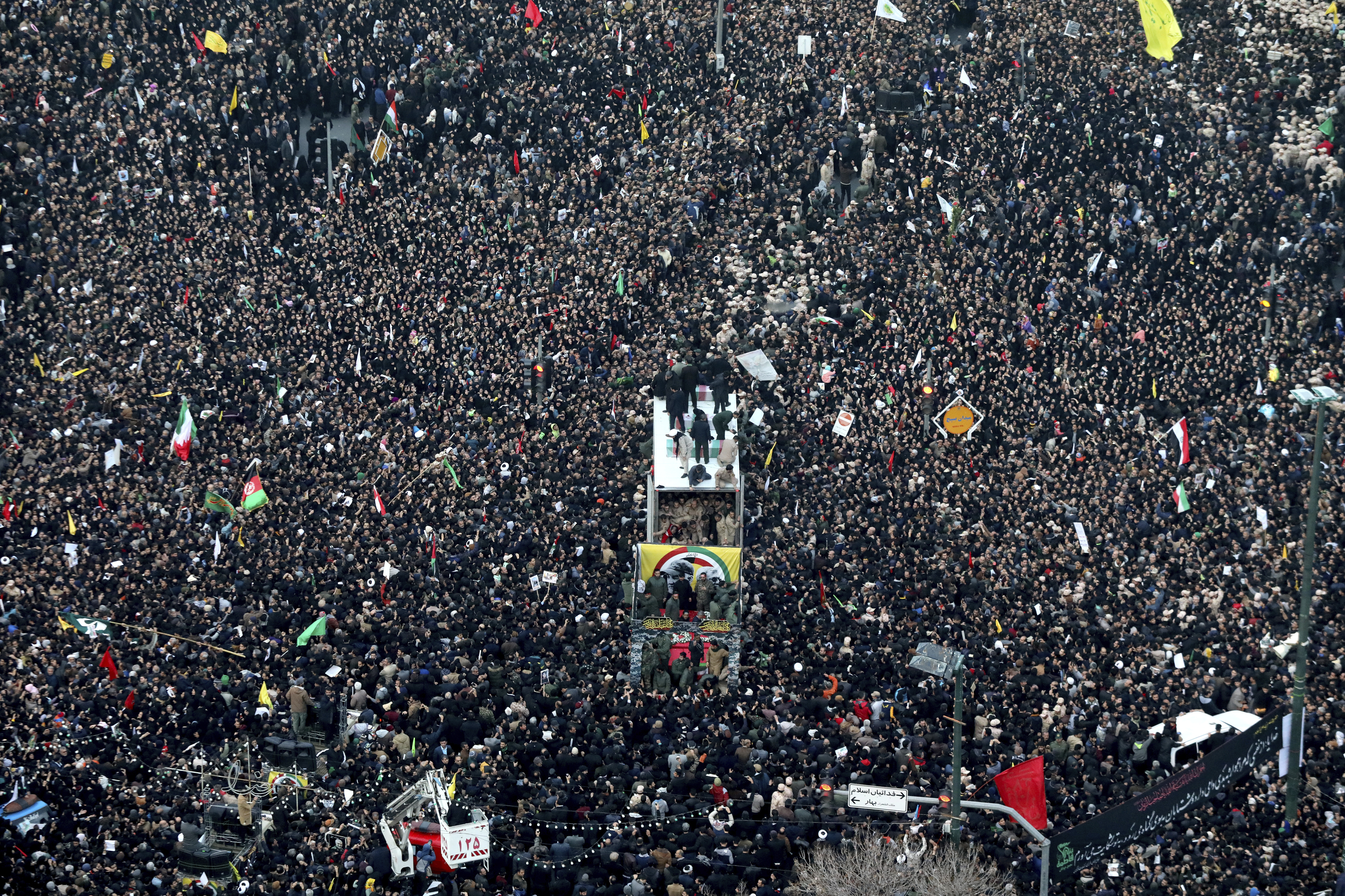 Coffins of Gen. Qassem Soleimani and others who were killed in Iraq by a US drone strike, are carried on a truck surrounded by mourners during a funeral procession, in the city of Mashhad, Iran, Sunday, January 5, 2020