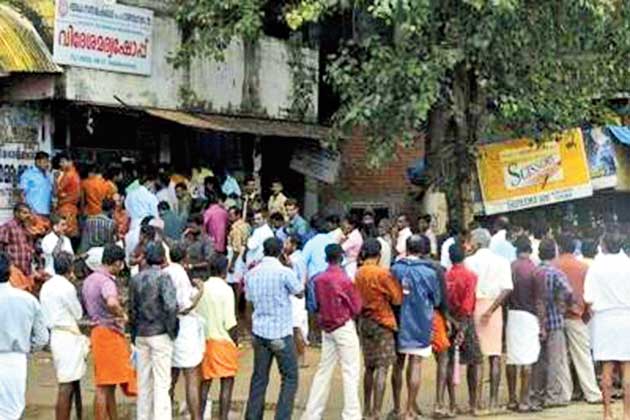 Regular queue at a liquor shop in Kerala.