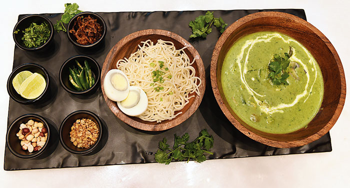 The Green Curry Khao Suey comes in three variants — vegetarian, chicken and prawn. The curry with your choice of protein or vegetables, is made with spiced coconut, chilli and lemongrass and is served with either egg noodles or rice and an assortment of condiments. 
Rs 535 prawn variant (in picture)