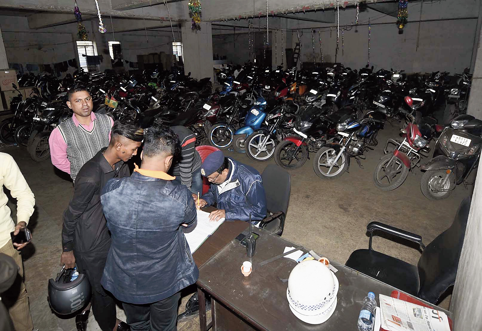 Two-wheeler owners at Chatterjee International Centre to claim their bikes after paying fines.