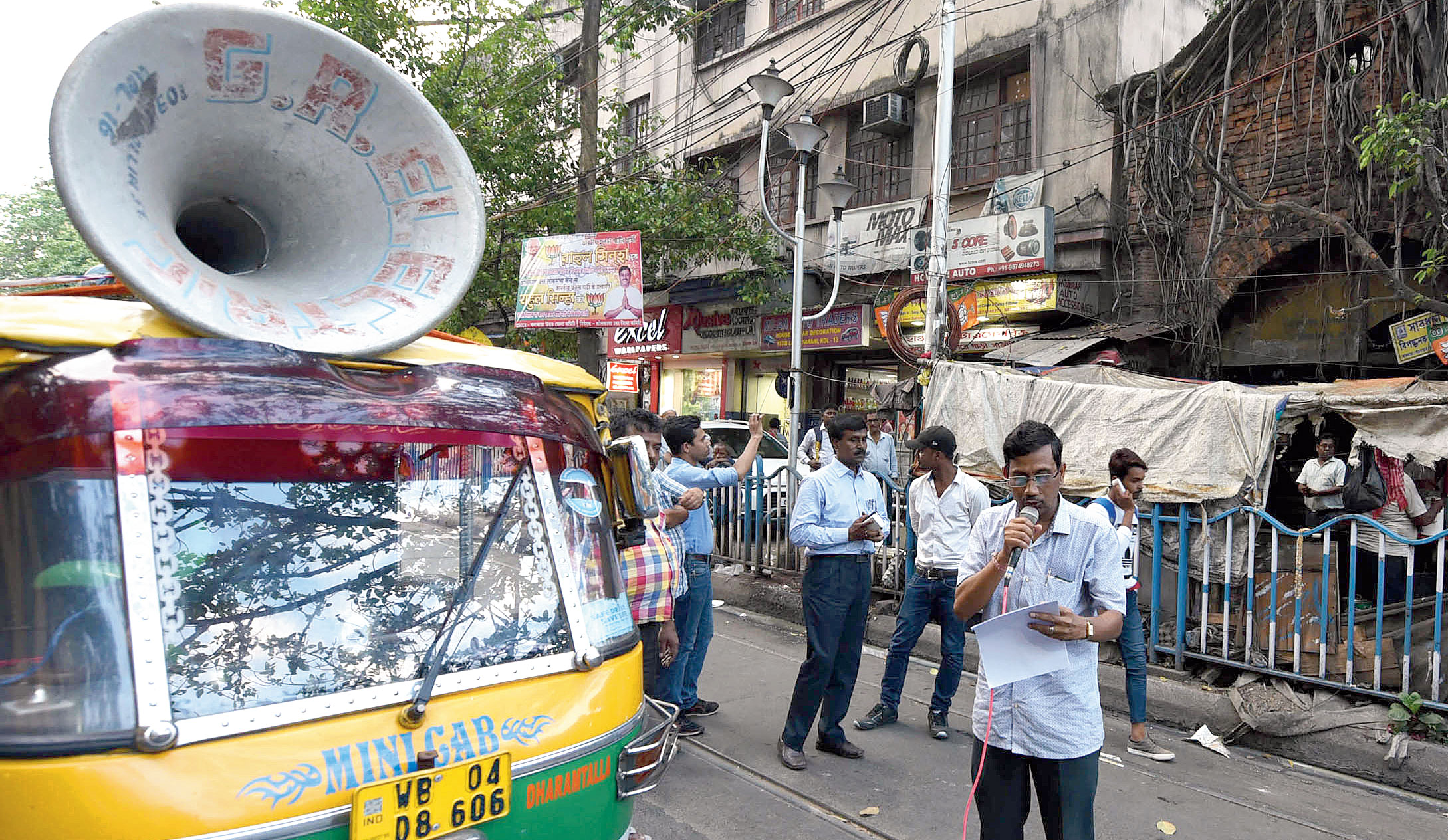 Announcements alerting people about Cyclone Fani on Lenin Sarani on Thursday.