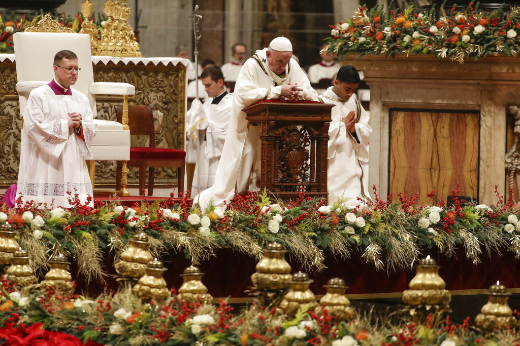 Pope Francis prays as he celebrates Christmas Eve Mass in St. Peter's Basilica at the Vatican, Tuesday, Dec. 24, 2019.