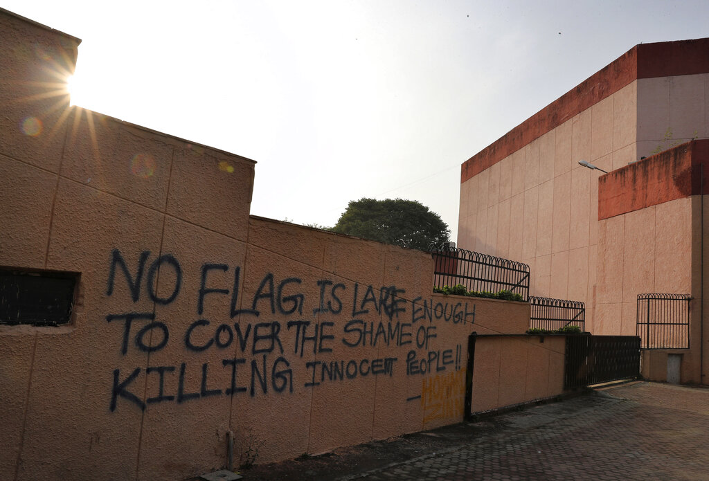 Graffiti in Jamia Millia Islamia that reads "No flag is large enough to cover the shame of killing innocent people," spray-painted in the university