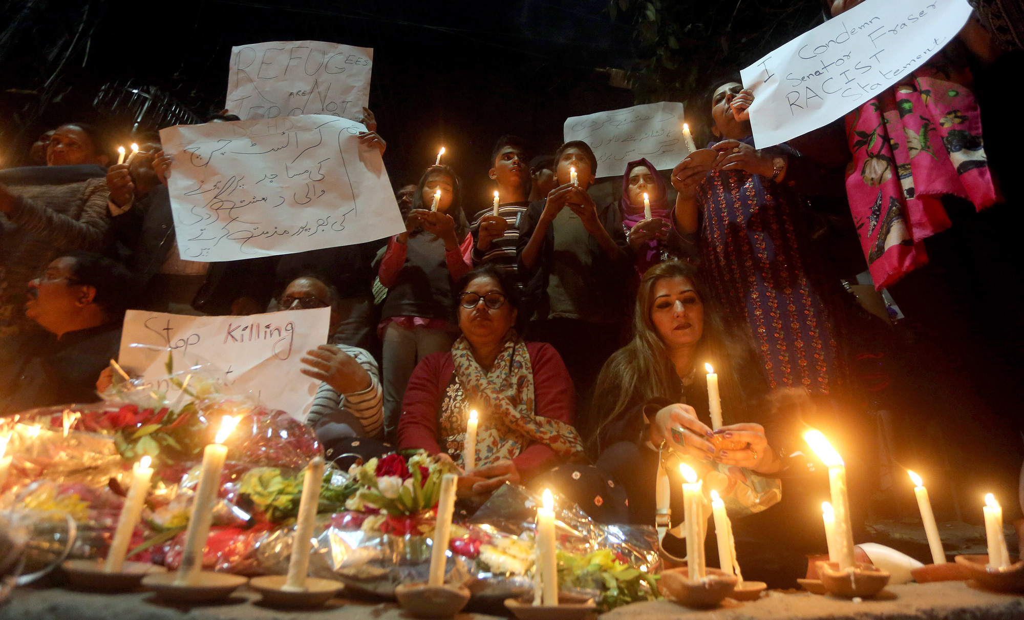 Members of civil society group 'Joint Action Committee for People Rights' hold a candle light vigil for the victims of Christchurch mosque shooting, in Lahore, Pakistan on Saturday, March 16, 2019. 