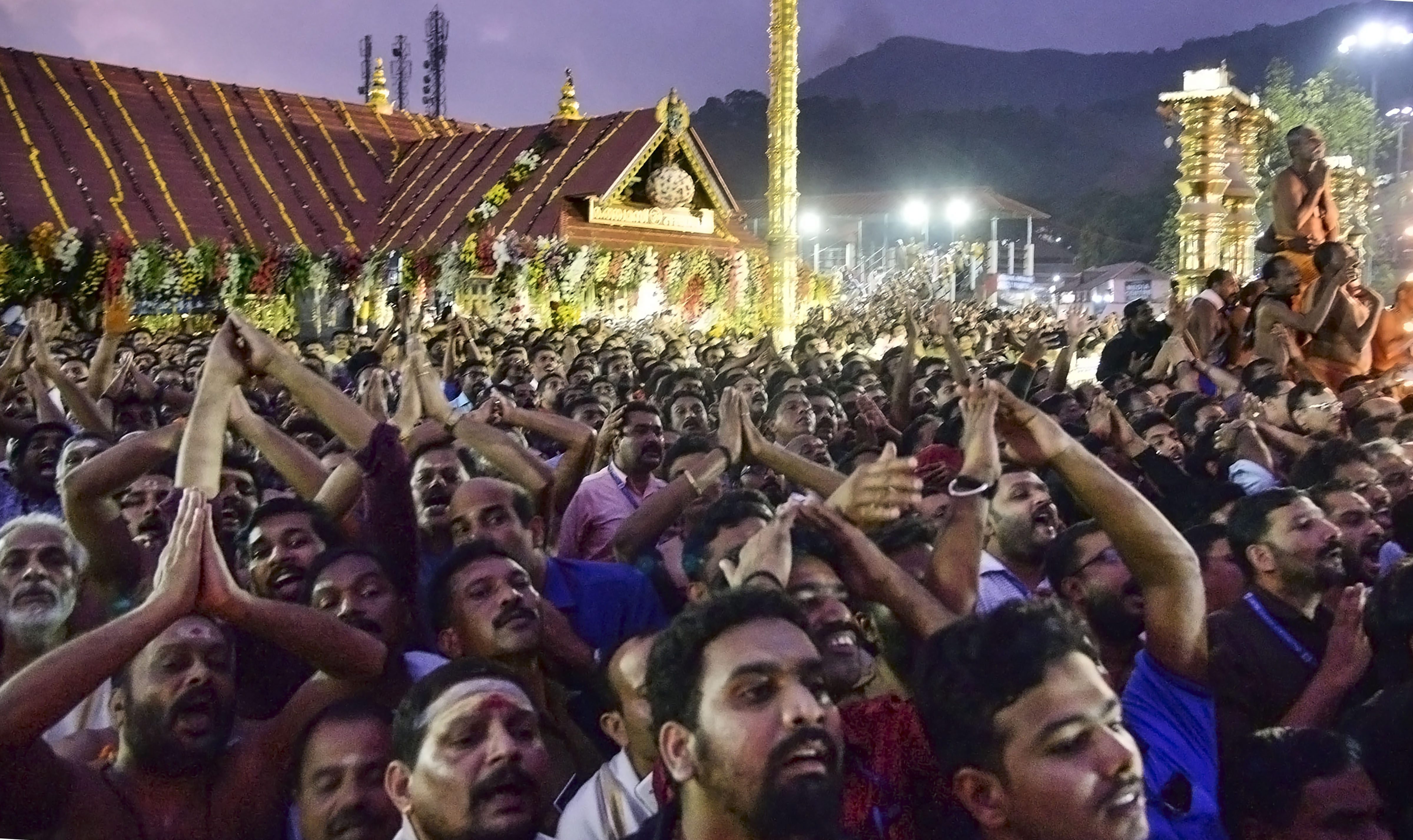 Devotees gather to offer prayers during the Makaravilakku festival at Sabarimala on Monday. 