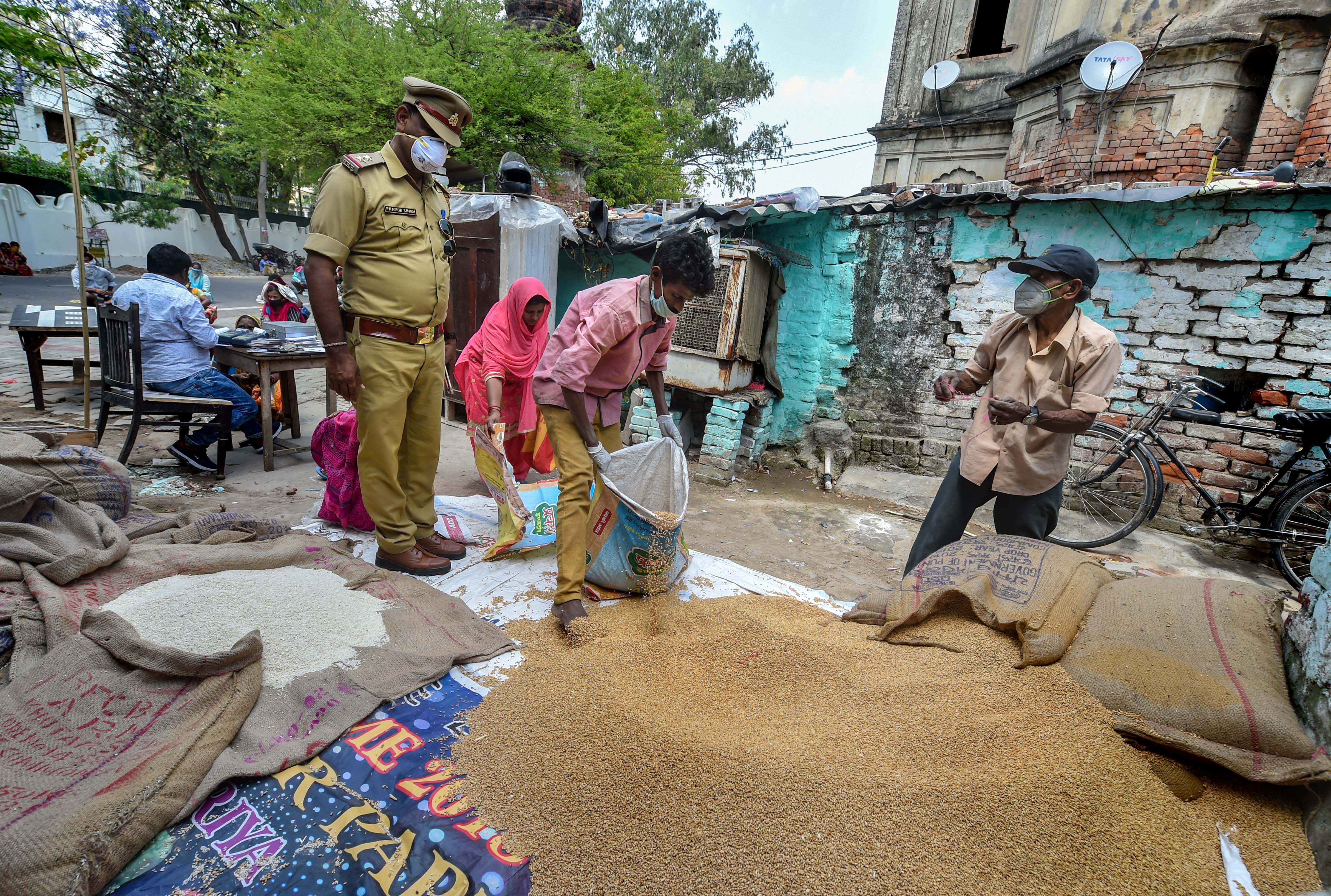 People maintain safe distance while collecting ration from a PDS centre, during the nationwide lockdown imposed to contain the coronavirus pandemic, in Lucknow, Wednesda, April 1 2020