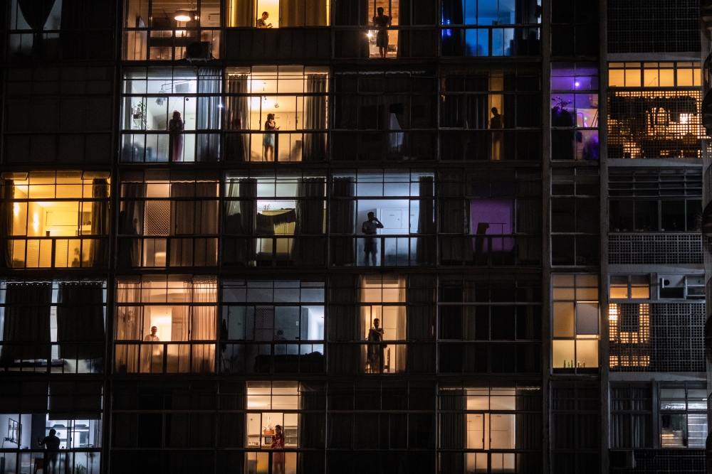 Living quarters are lit up in São Paulo, Brazil, on Wednesday, March 19, 2020, where many people are staying home because of the coronavirus