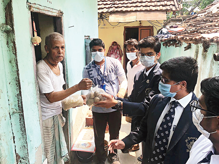 Students of St James’ School distribute essential items to residents of Duttabad in Salt Lake
