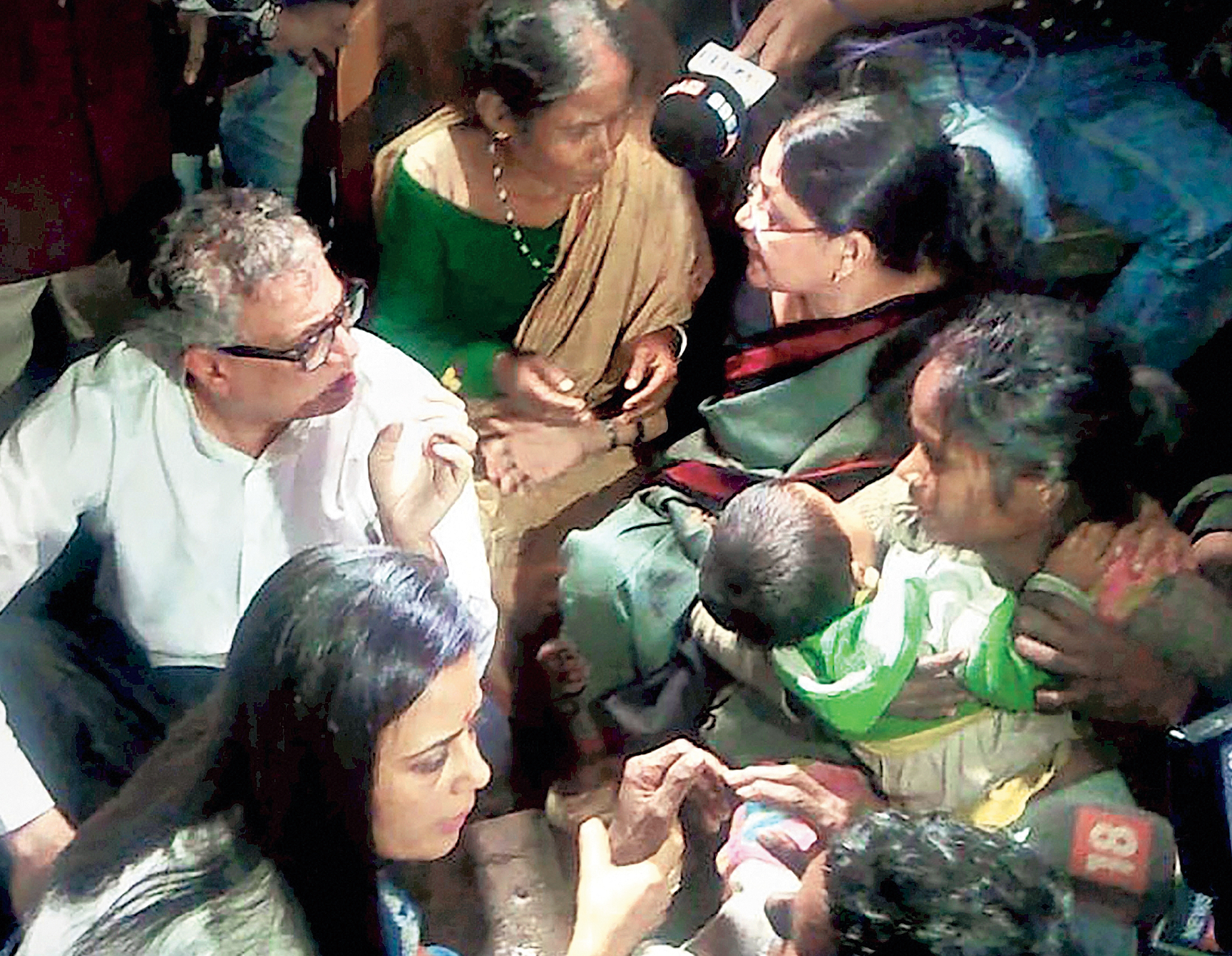 Trinamul leaders with family members of those killed by armed men at Dhola in Tinsukia on Sunday. 