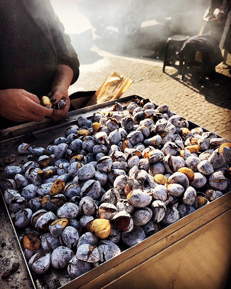 A street vendor roasting chestnuts in winter