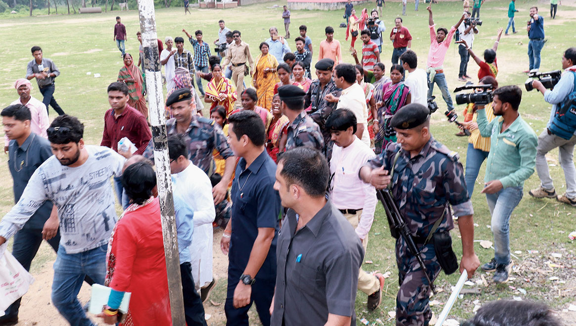 Ghosh being escorted out of a booth in Keshpur after being heckled by Trinamul supporters. 