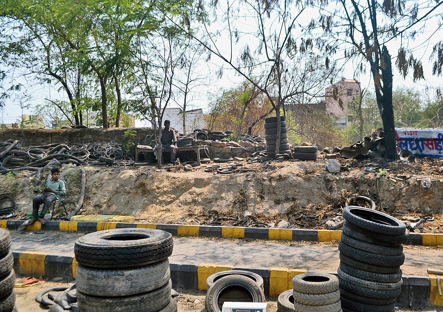 Tyres pile up near the broken railway boundary in Jugsalai, Jamshedpur, on Friday.
