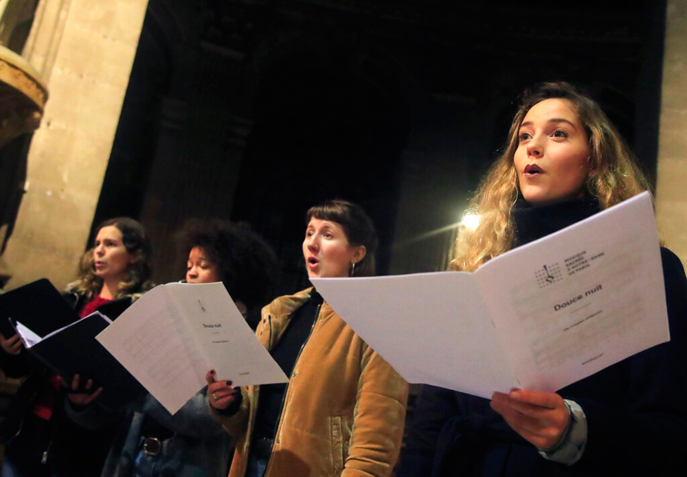The members of the Notre Dame cathedral choir in Paris on December 16. An accidental fire stopped the Paris cathedral from celebrating Midnight Mass this year for the first time in over two centuries