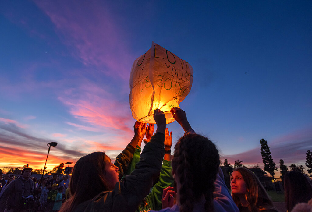 Classmates and friends of Alyssa Altobelli launch a lantern in her memory during a vigil in Newport Beach, California on Thursday