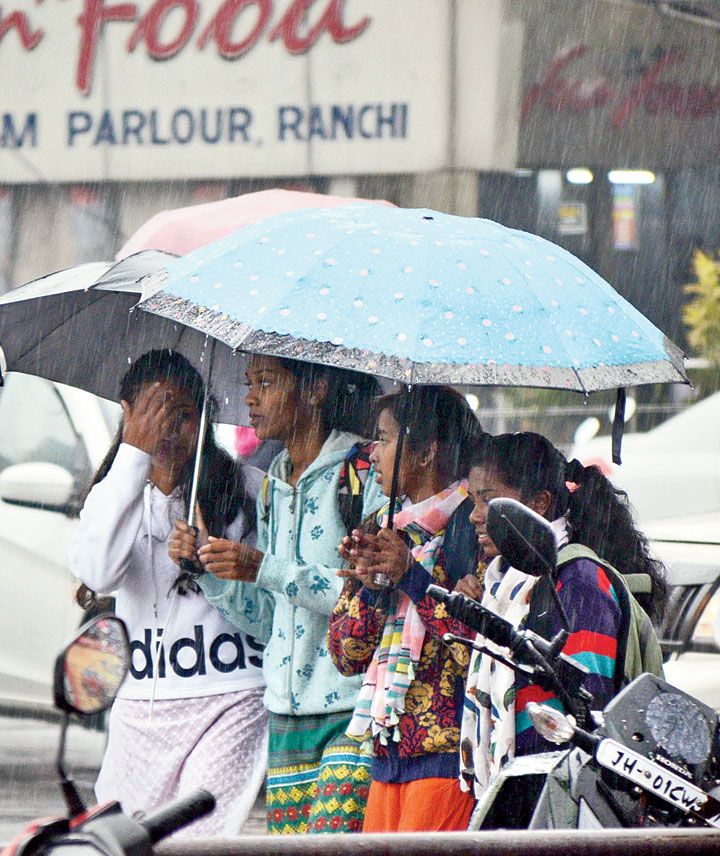 Girls with umbrellas on a rainy Sunday in Ranchi. 