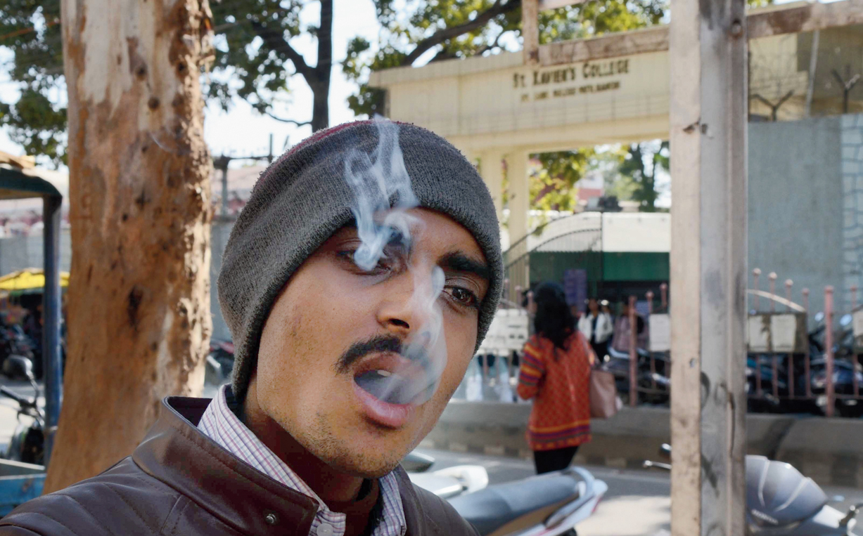 A man smokes at a tobacco shop near St Xavier’s College on Purulia Road in Ranchi on Friday.
